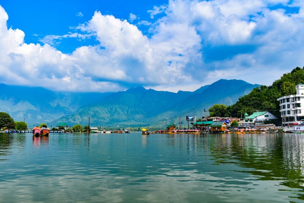 Explore the stunning Dal Lake in Kashmir with the majestic Himalayas in the background.