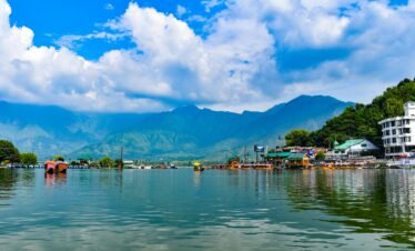 Explore the stunning Dal Lake in Kashmir with the majestic Himalayas in the background.