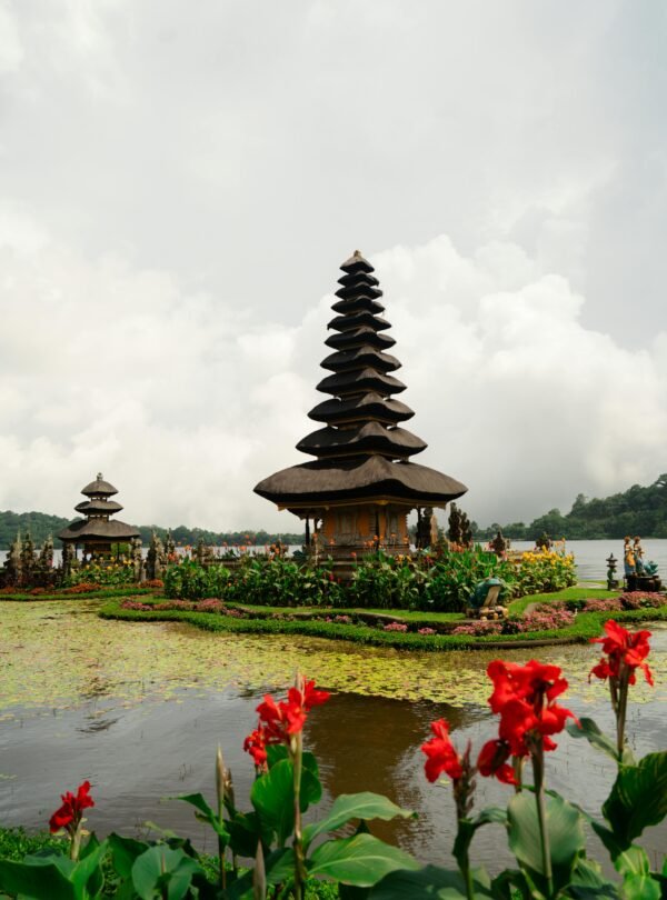 Pura Ulun Danu Beratan on tranquil Lake Bratan amidst scenic flora in Bali, Indonesia.